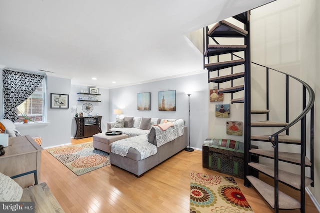 living room with light hardwood / wood-style floors and crown molding