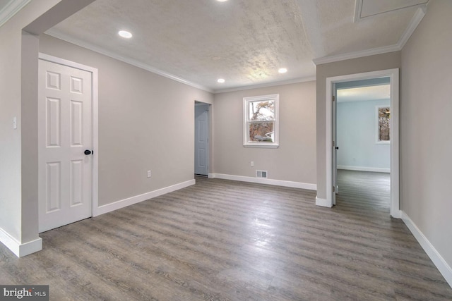 unfurnished room with hardwood / wood-style floors, a textured ceiling, and ornamental molding