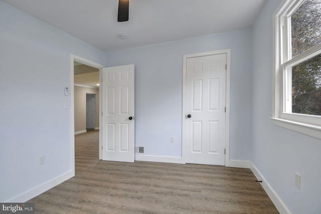 unfurnished bedroom featuring ceiling fan and wood-type flooring