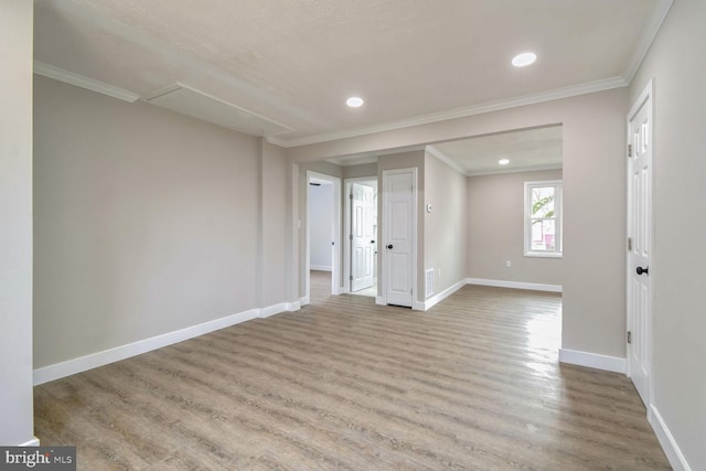 spare room with light hardwood / wood-style flooring and ornamental molding