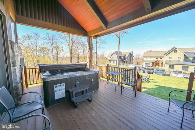 deck featuring a yard and a hot tub