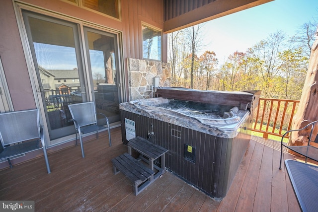 wooden deck with a hot tub