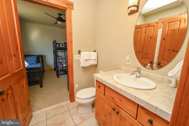 bathroom with vanity, toilet, tile patterned floors, and ceiling fan