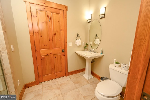 bathroom featuring toilet and tile patterned flooring