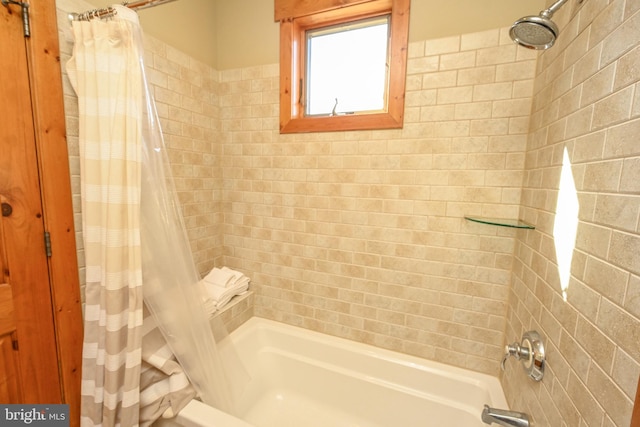 bathroom featuring shower / bathtub combination with curtain