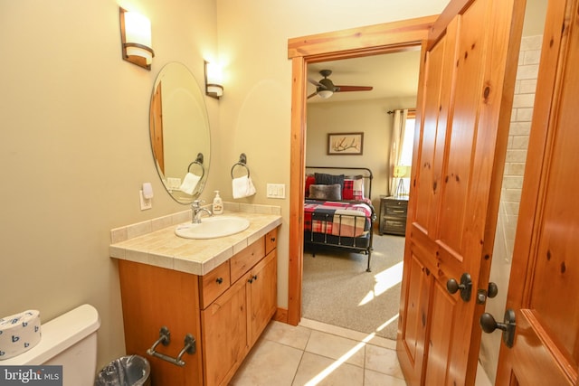 bathroom featuring vanity, tile patterned flooring, toilet, and ceiling fan