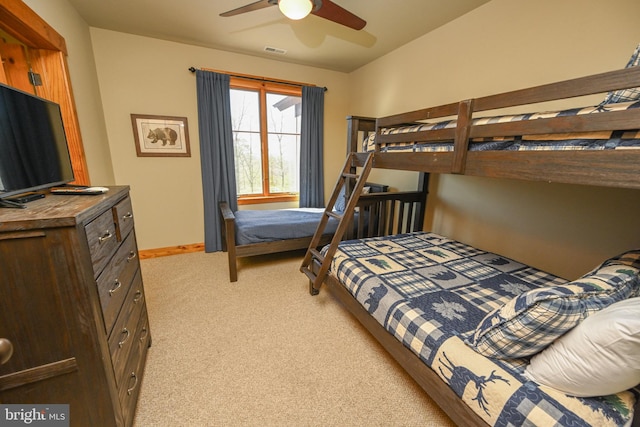 bedroom with ceiling fan and light carpet