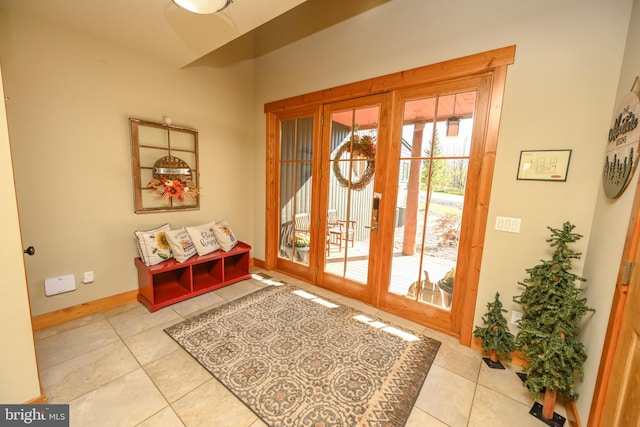 entryway with french doors, light tile patterned floors, and a wealth of natural light