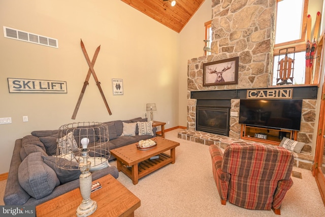 living room featuring wood ceiling, high vaulted ceiling, carpet floors, and a stone fireplace