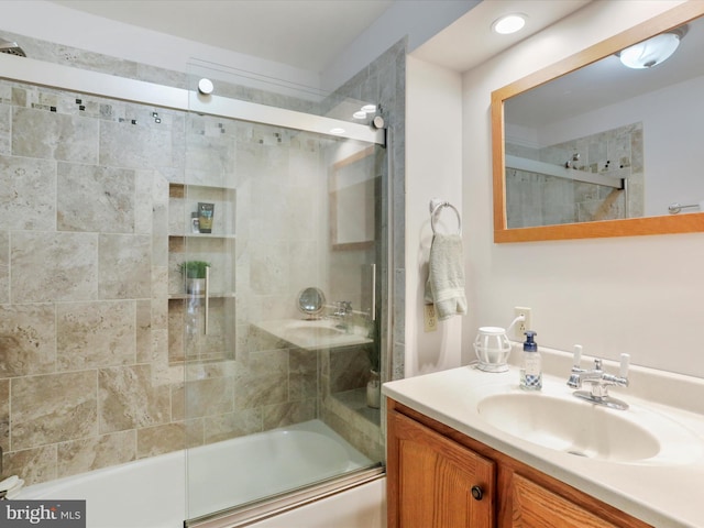 bathroom featuring vanity and shower / bath combination with glass door