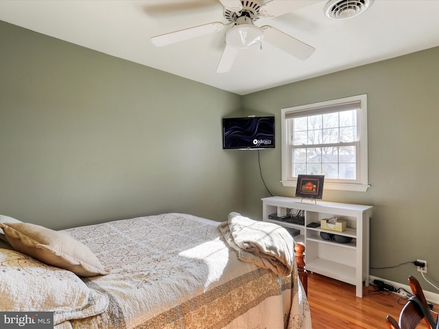 bedroom with light hardwood / wood-style flooring and ceiling fan