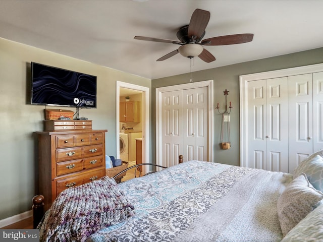 bedroom featuring ensuite bath, two closets, washing machine and dryer, and ceiling fan