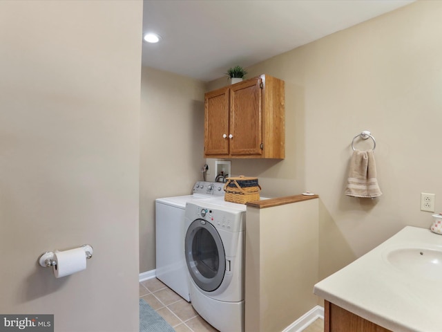 laundry area featuring cabinets, separate washer and dryer, and light tile patterned floors