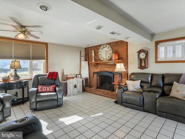 tiled living room featuring ceiling fan and a fireplace