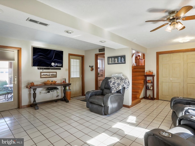 tiled living room featuring ceiling fan