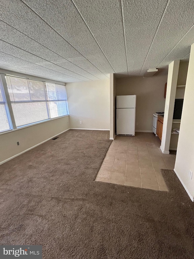 unfurnished living room featuring light colored carpet