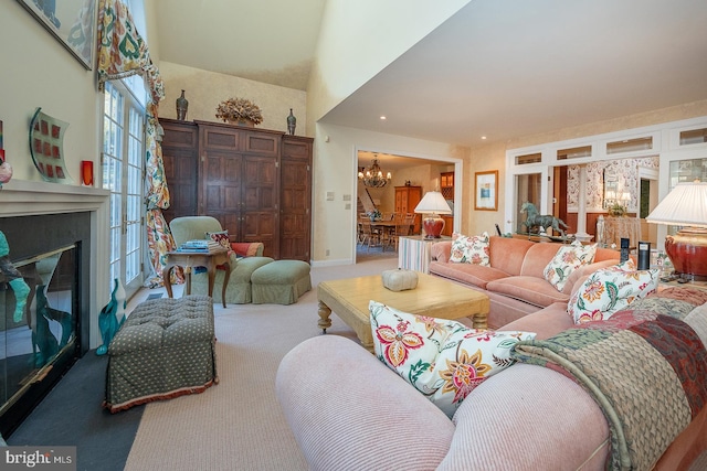 carpeted living room with a chandelier