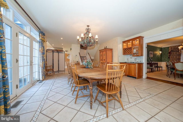 dining room featuring an inviting chandelier and light tile patterned floors