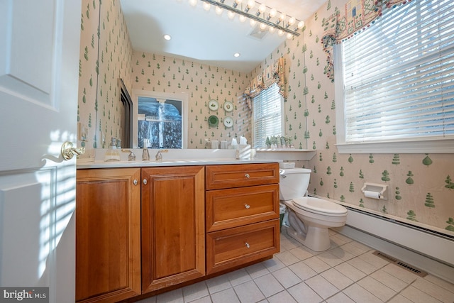 bathroom with vanity, toilet, tile patterned floors, and a baseboard radiator