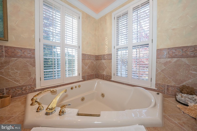 bathroom with ornamental molding, a wealth of natural light, tiled tub, and tile walls