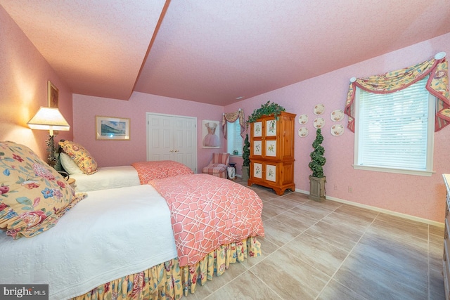 bedroom with a closet and a textured ceiling