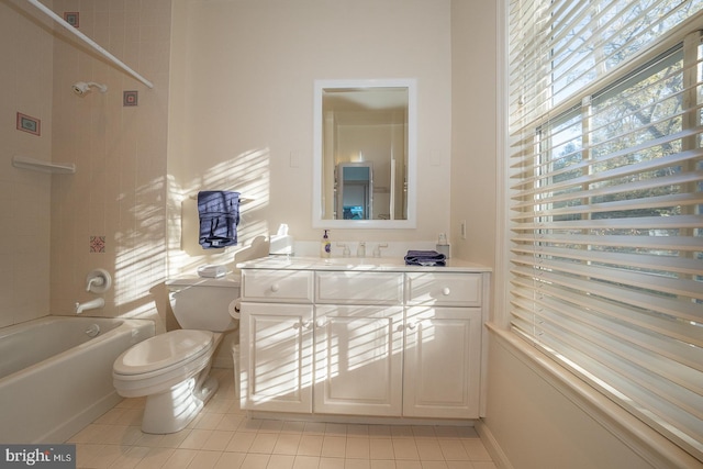 full bathroom with tiled shower / bath, vanity, toilet, and tile patterned floors