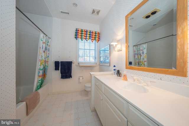 full bathroom with vanity, toilet, a textured ceiling, and shower / tub combo with curtain