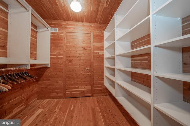 spacious closet with hardwood / wood-style flooring