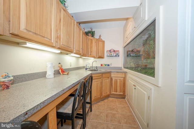 kitchen with sink, light brown cabinetry, and light tile patterned floors