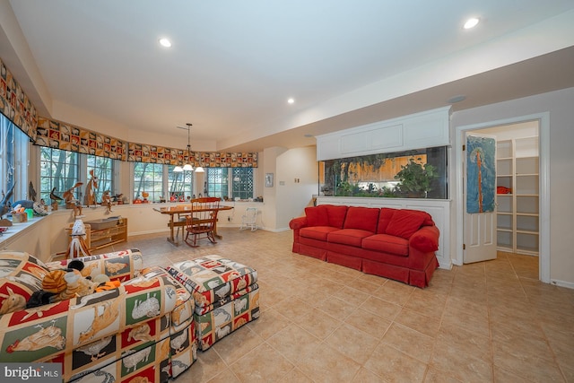 living room featuring an inviting chandelier and light tile patterned floors