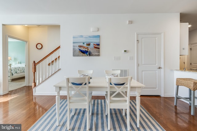 dining space with breakfast area and dark hardwood / wood-style flooring