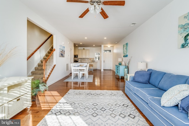 living room featuring ceiling fan and hardwood / wood-style flooring