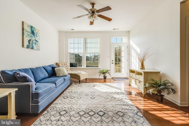 living room featuring dark hardwood / wood-style floors and ceiling fan