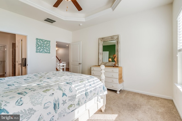 carpeted bedroom with ornamental molding, a raised ceiling, and ceiling fan