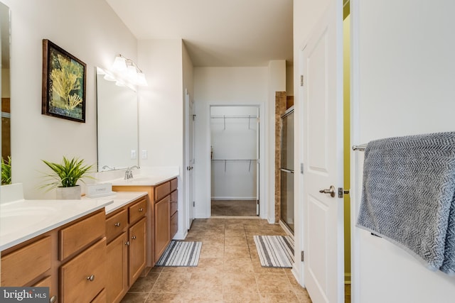 bathroom with vanity, tile patterned floors, and a shower with shower door