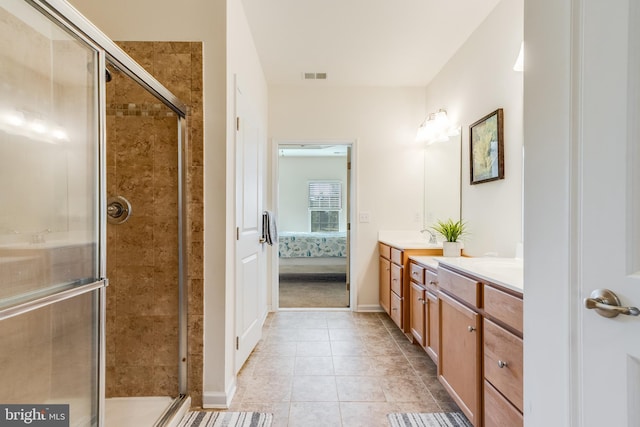 bathroom with vanity, walk in shower, and tile patterned flooring