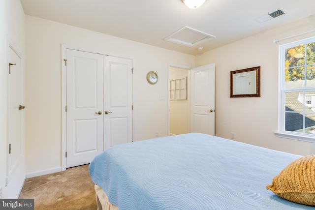 bedroom with a closet and light carpet