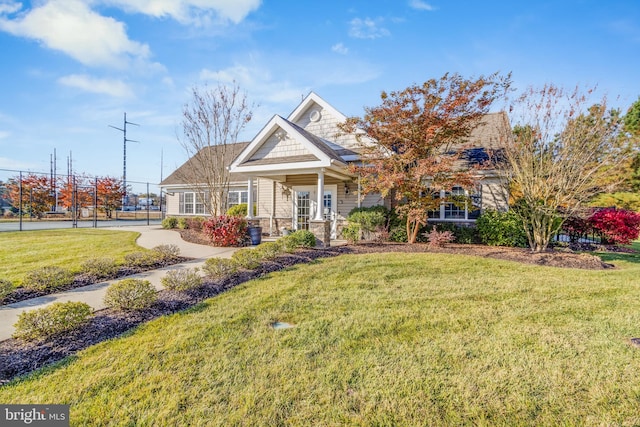 craftsman inspired home with a front lawn