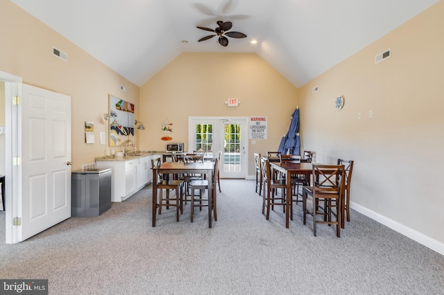 dining area featuring lofted ceiling, french doors, carpet, and ceiling fan