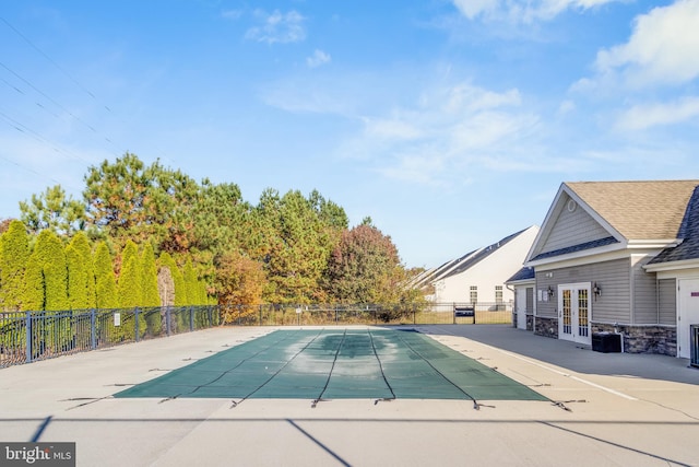 view of swimming pool with french doors and a patio area