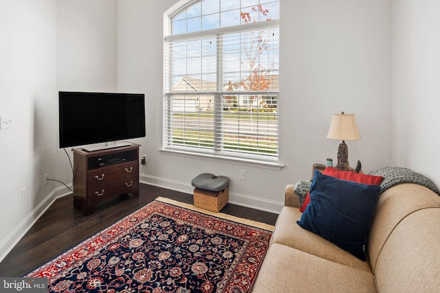 living room with a healthy amount of sunlight and dark hardwood / wood-style floors