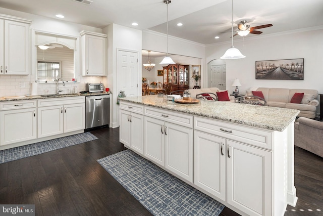 kitchen featuring sink, hanging light fixtures, stainless steel dishwasher, white cabinets, and dark wood-type flooring