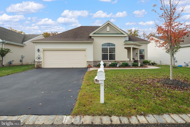 view of front of house featuring a garage and a front lawn