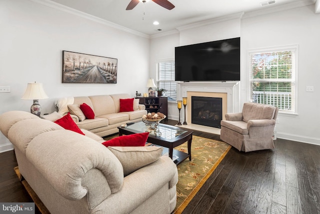 living room with hardwood / wood-style floors, crown molding, and ceiling fan