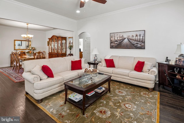 living room featuring ornamental molding, ceiling fan with notable chandelier, and dark hardwood / wood-style flooring