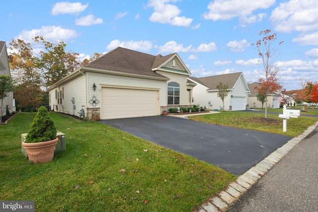 view of front of house with a front yard and a garage