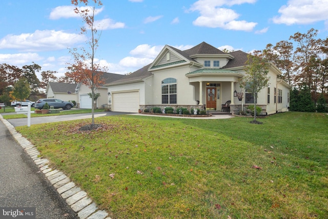 view of front of property with a front yard and a garage