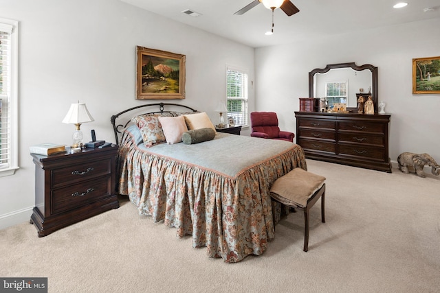 bedroom featuring light colored carpet and ceiling fan