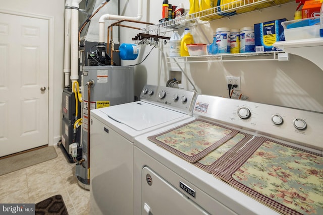 washroom with water heater and separate washer and dryer