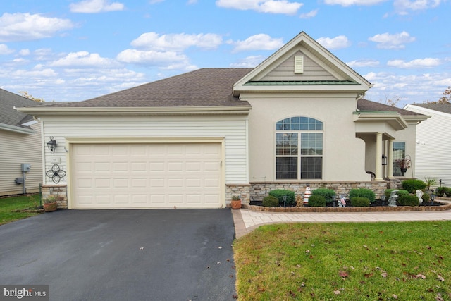 view of front of home featuring a front lawn and a garage